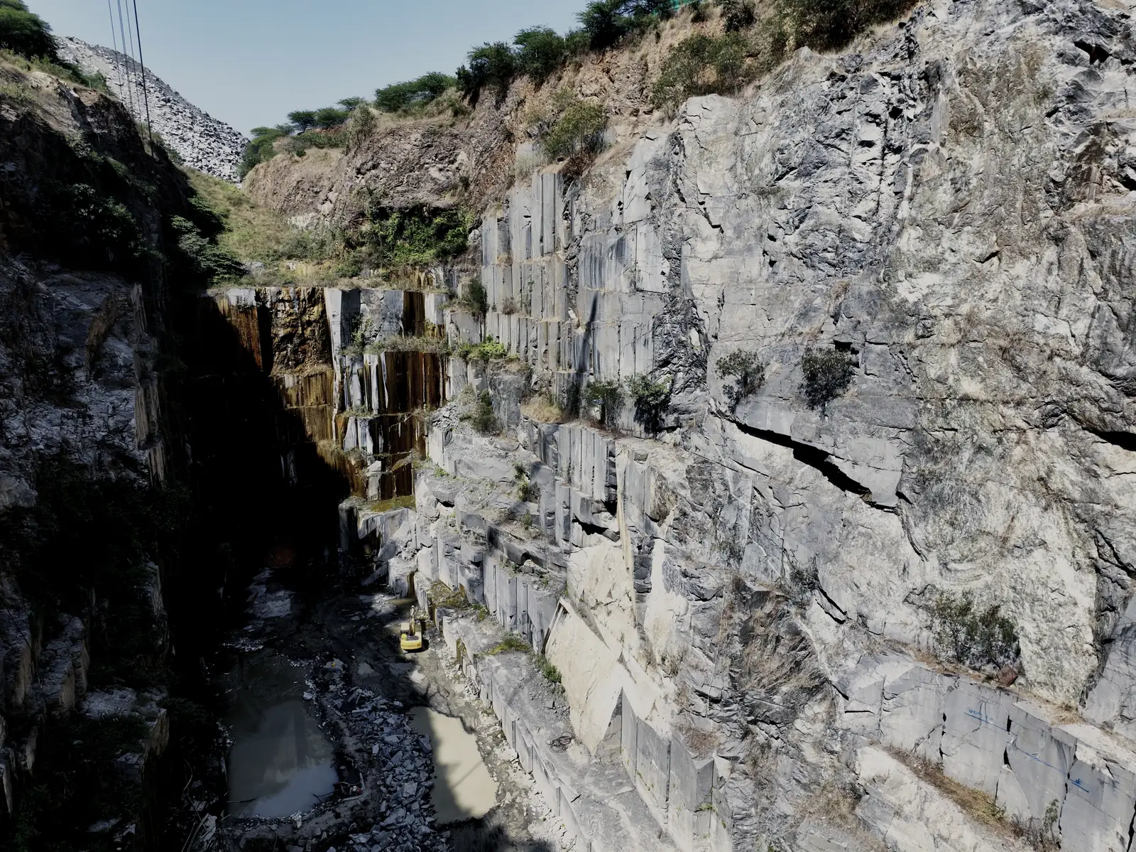 A granite quarry set into the hillside, seen from the rim