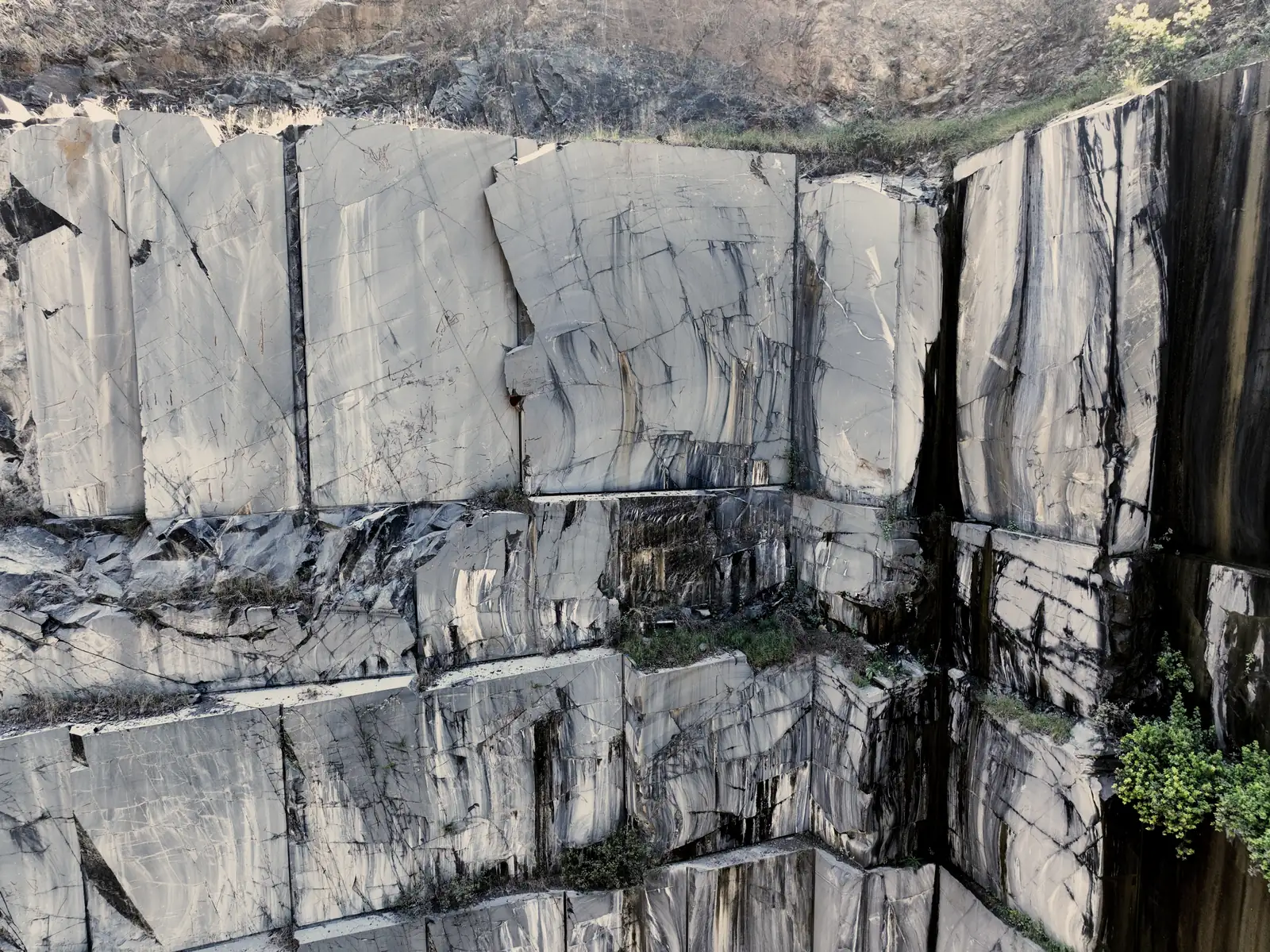 Granite bench faces cut flat and square across the full height of the wall